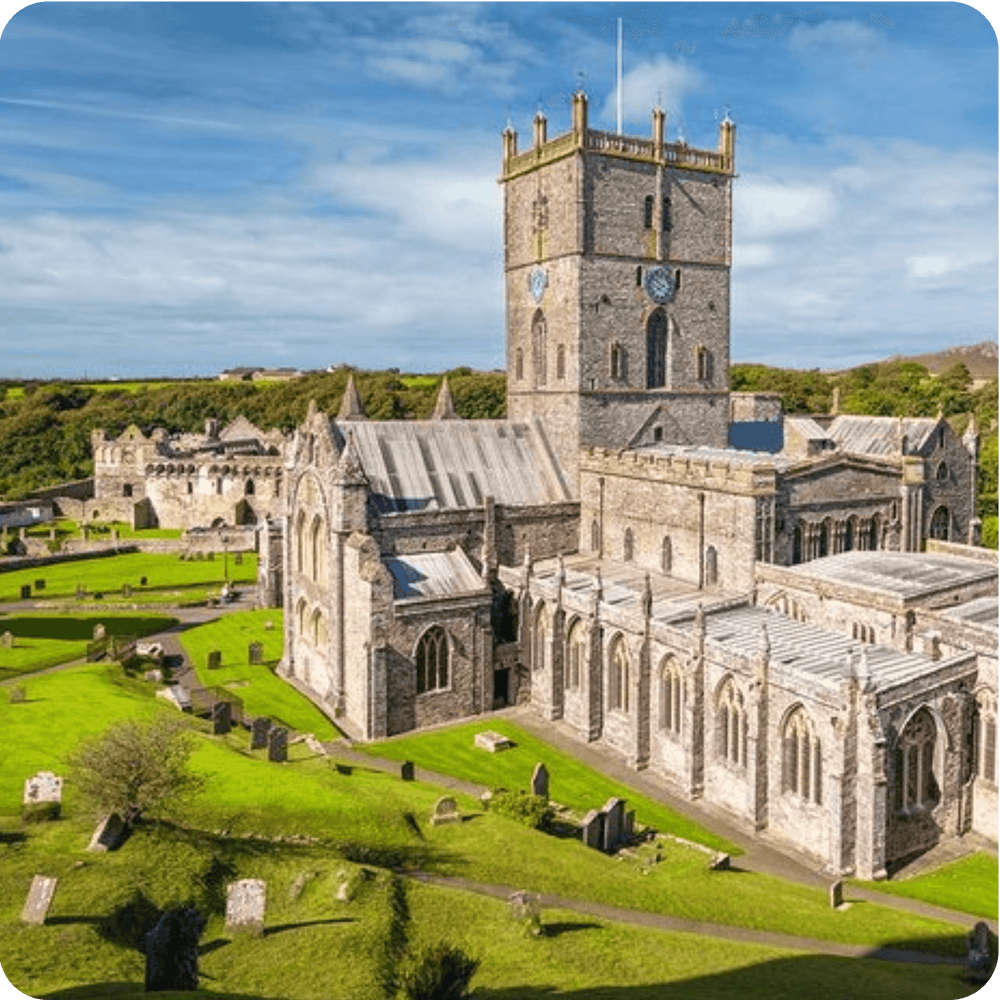 
                  
                    St. Davids Cathedral with green landscapes, a historic site in Wales, ideal for UK tours from London.
                  
                