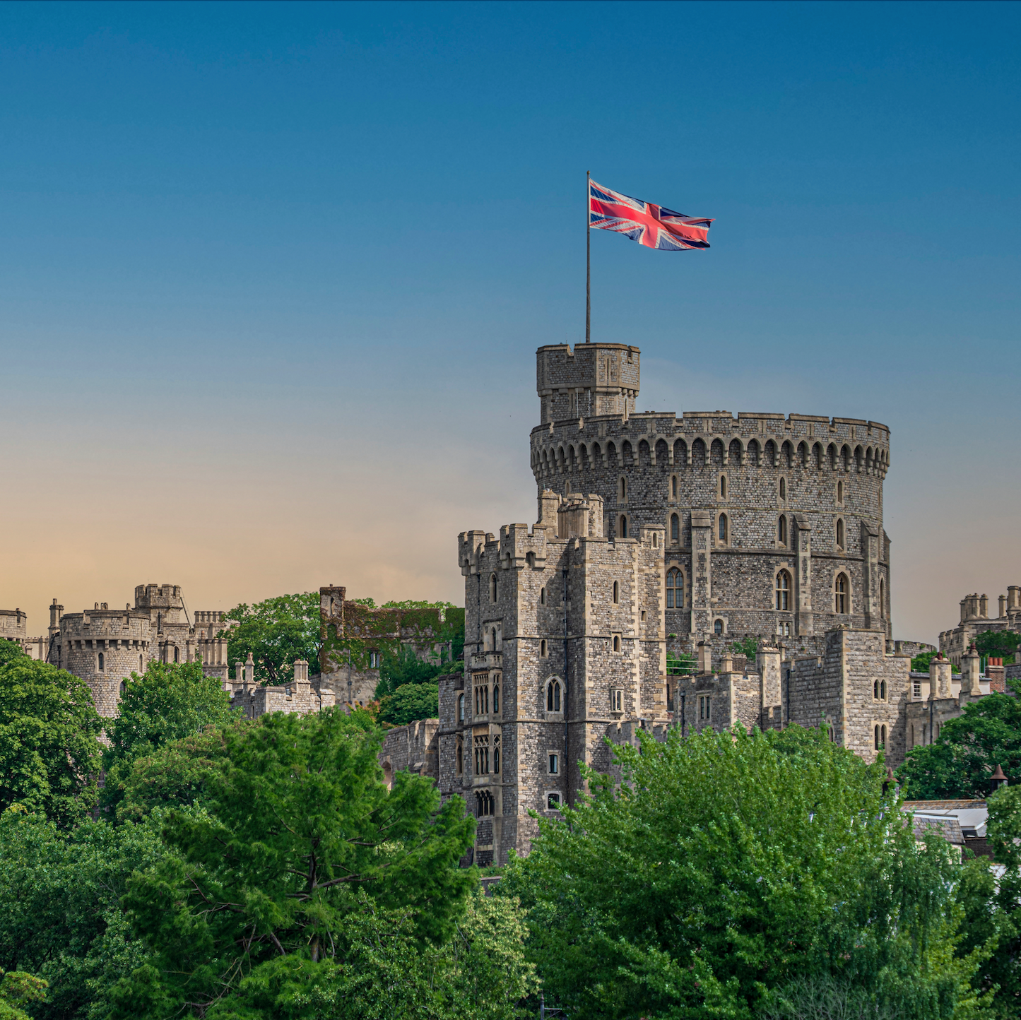 Windsor Castle with a British flag on a clear day
